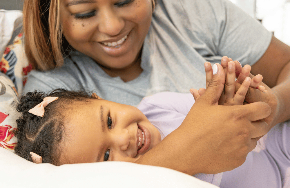 Mom cuddling with daughter