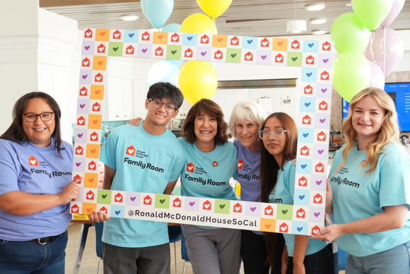 smiling volunteers holding frame