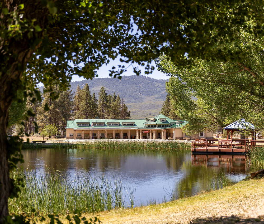 Camp Ronald McDonald Dining Hall with the pond and fishing dock in front of it.