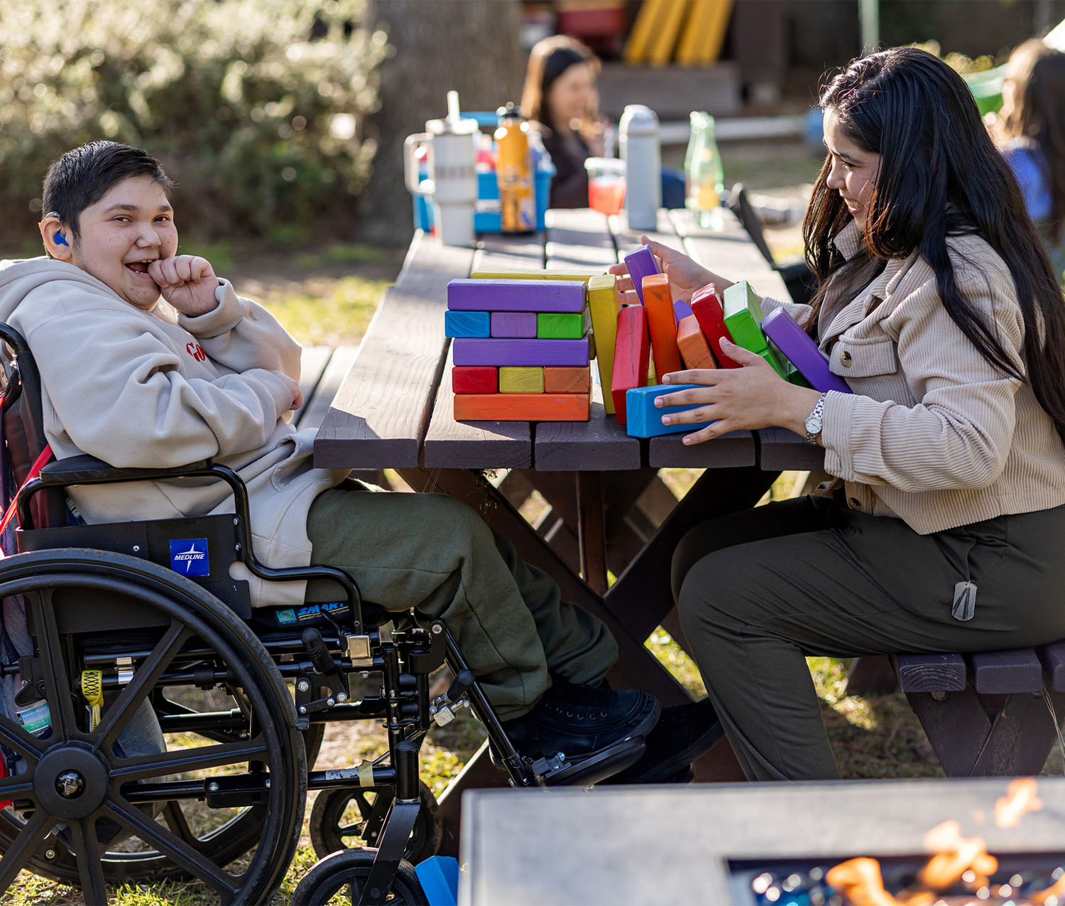volunteer and child playing building blocks in the yard