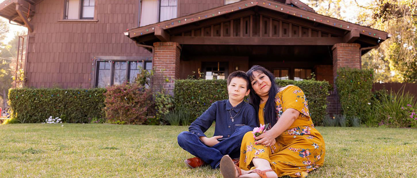 mom and son sitting on the lawn