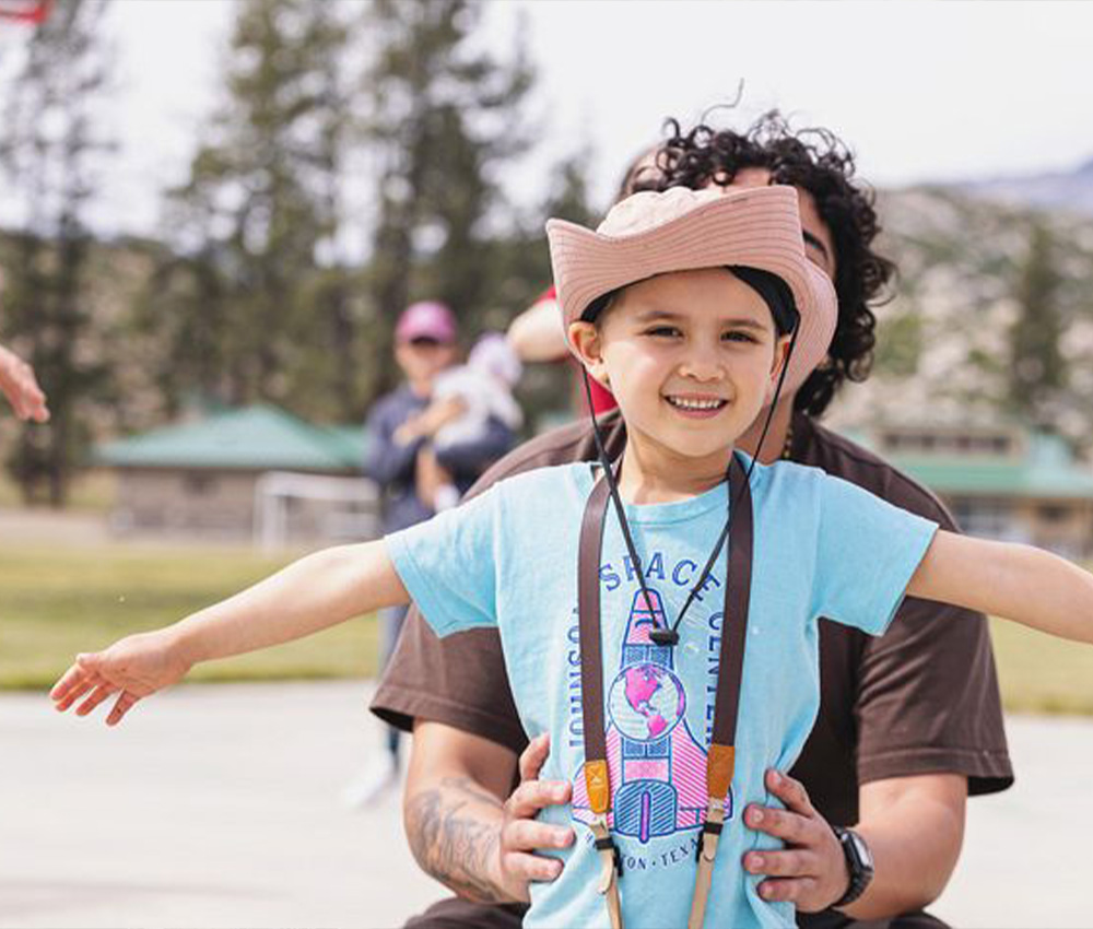girl looking at camera spreading arms happily