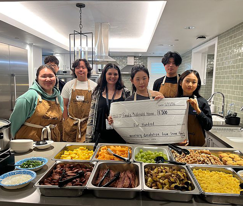 the Irvine family holding a donation check