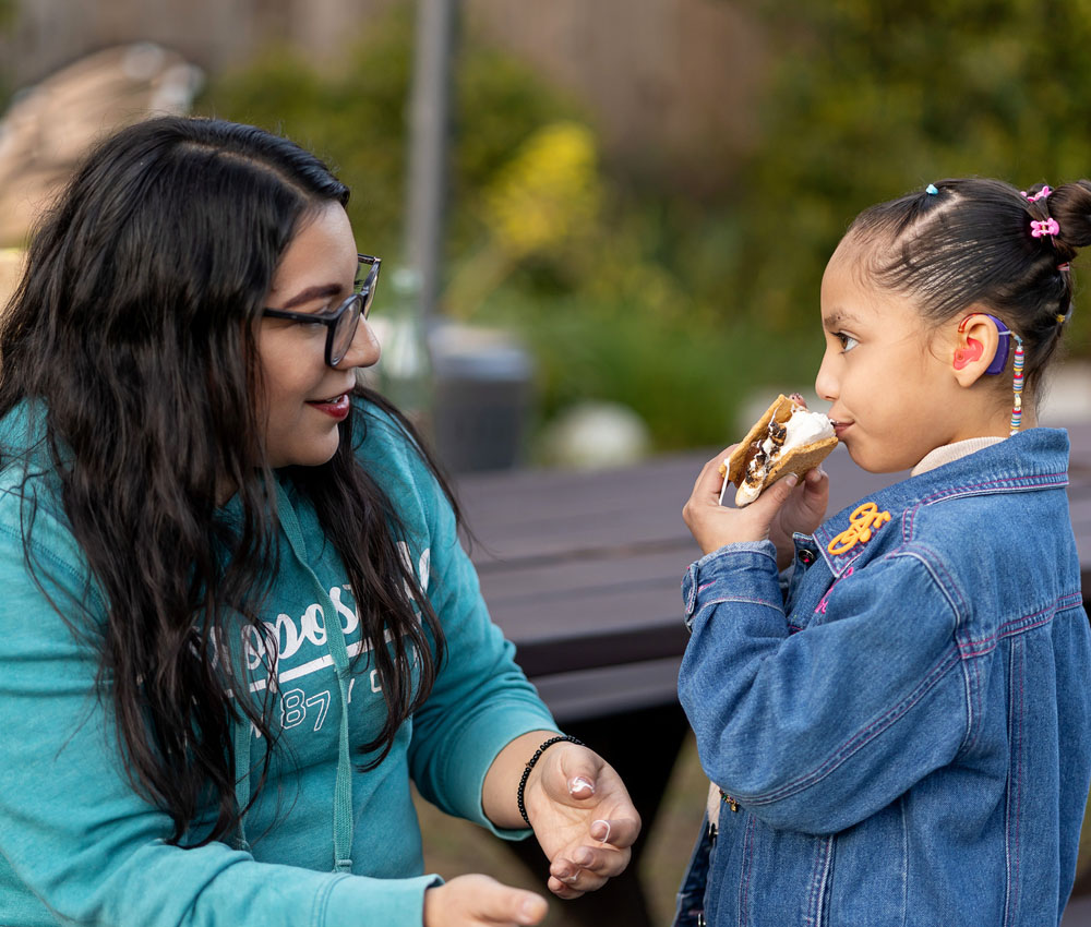 volunteer giving a girl ice cream
