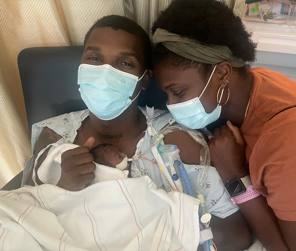 The kindred family hugging with newborn affectionately